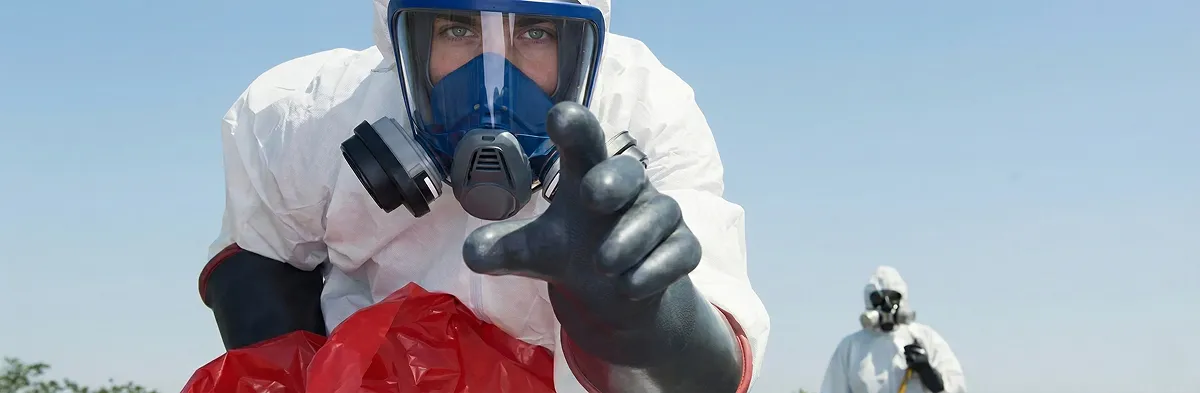 sewage clean up technician wearing protective gear handling biohazard materials in Indianapolis, IN